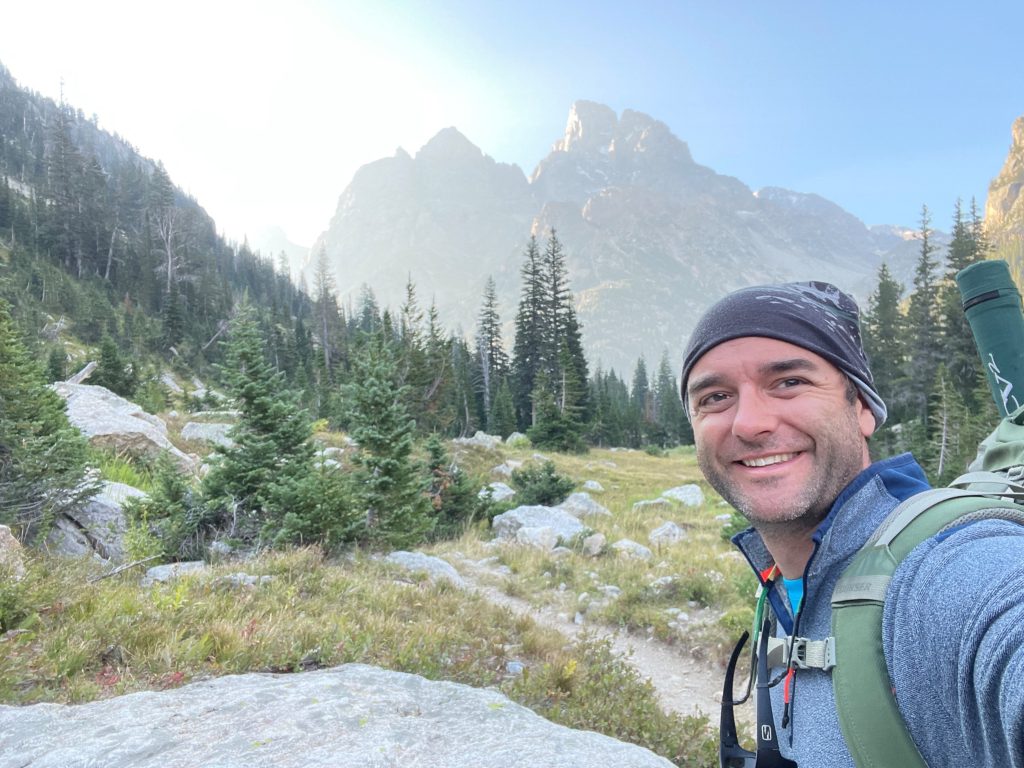 Photo of Professor Jesse Hampton in mountain landscape. 