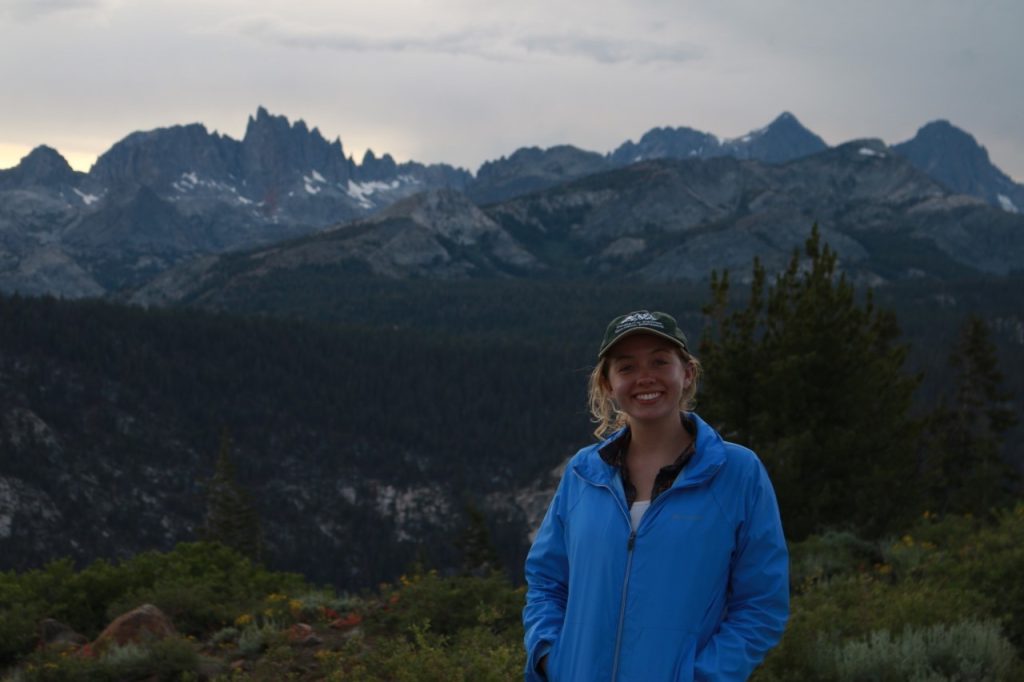 Photo of Ellie Johnson in mountain landscape.