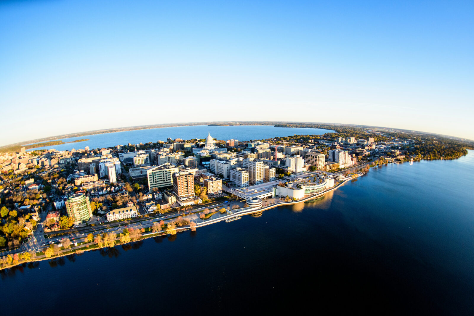 Aerial view of the city of Madison, showing the downtown area that is on an isthmus, an area that is surrounded by two lakes